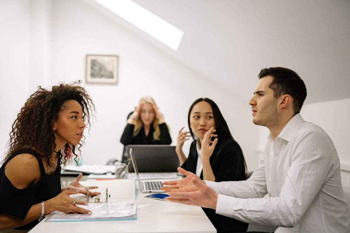 Team im Streitgespräch am Bürotisch
